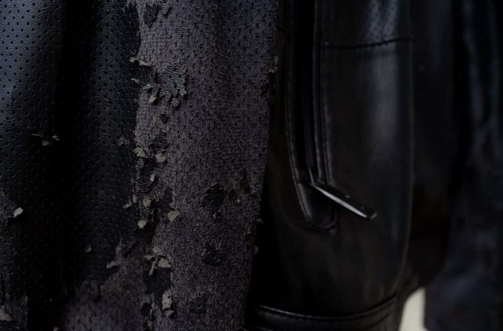 Damaged black leather image