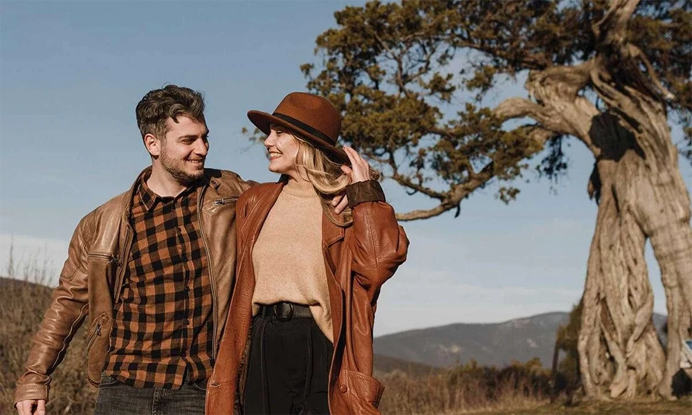 couple wearing brown leather jackets