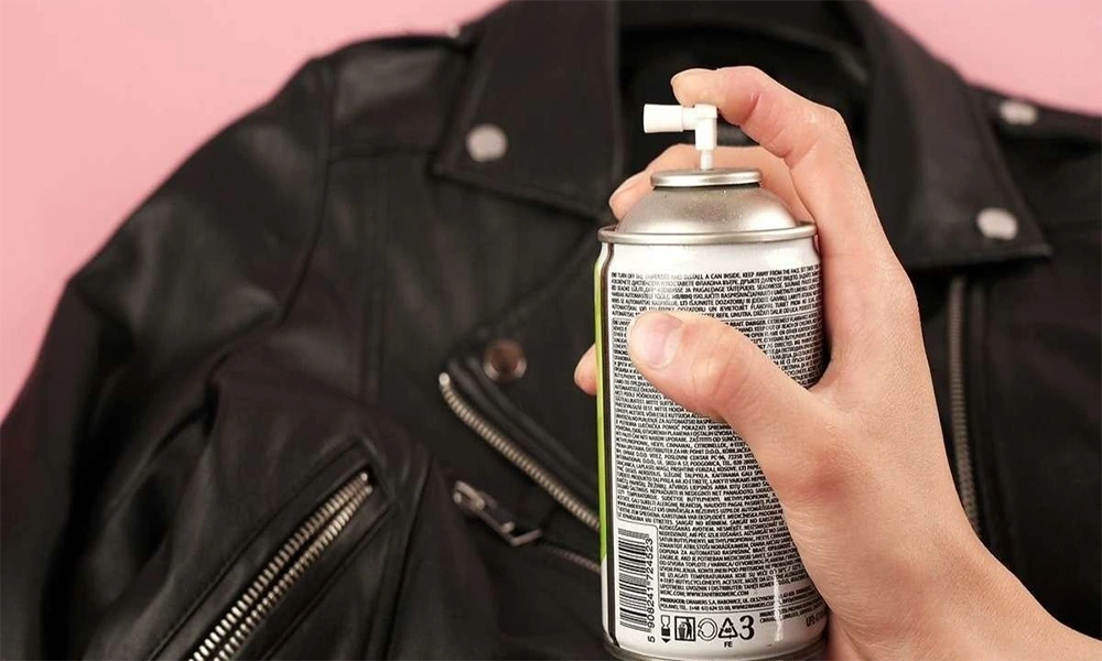 hand spraying leather jacket