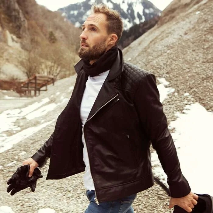 man-walking-in-snow-in-leather-jacket