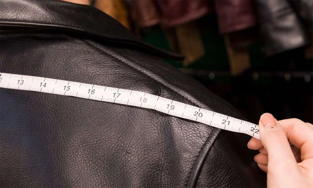 measuring tape on black leather jacket shoulder