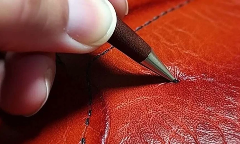 repairing scratch on red leather with pen