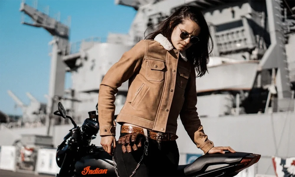 woman on motorcycle in tan leather jacket