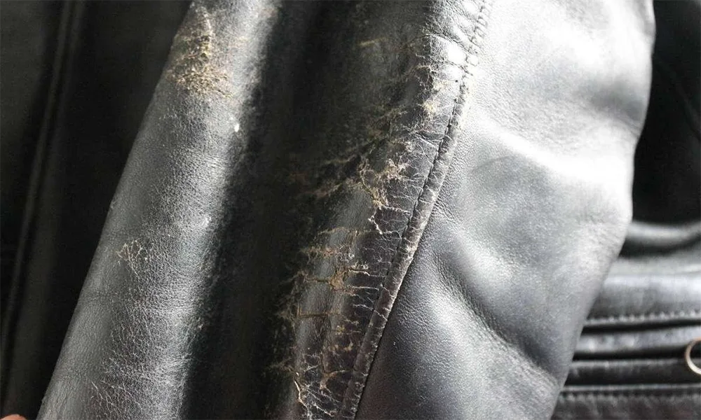 worn cracked black leather jacket